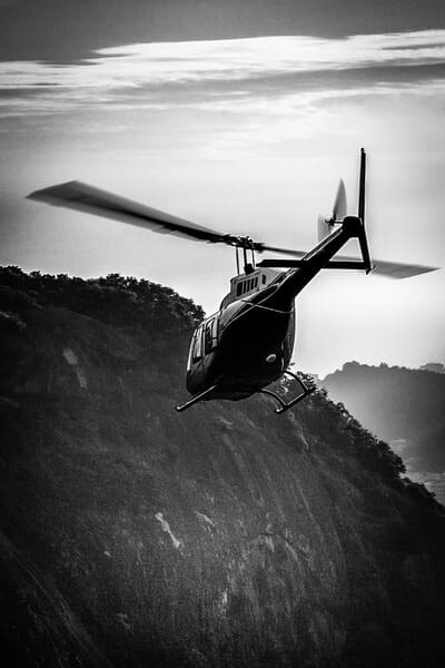 A black and white image of a helicopter in flight, capturing the essence of a thrilling Valentine's Day experience over Adelaide's scenic landscapes, perfect for adventurous couples seeking an unforgettable date.