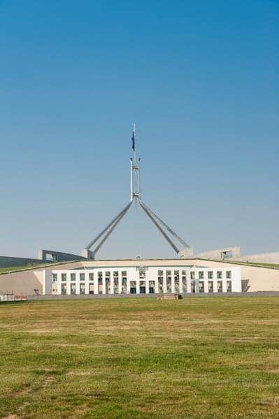 Parliament House in Canberra, the capital of Australia, under a clear blue sky, correcting the misconception that Sydney is the capital as discussed in the blog post.