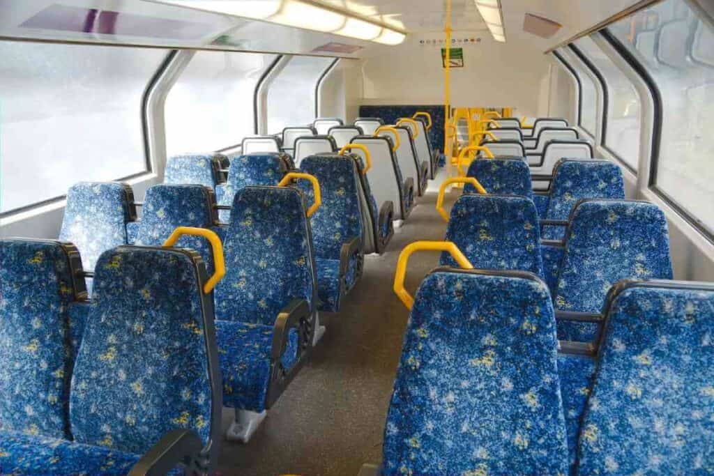 Interior of a Sydney train with empty seats, illustrating the comfort and space of public transport options, which highlights the convenience and alternative benefits of using rideshare services in Sydney.
