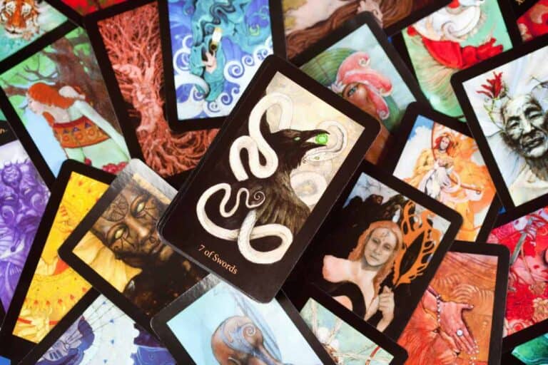 Assorted tarot cards spread out, featuring vibrant, mystical artwork, used for Halloween rituals in Australia to predict and guide spooky celebrations.