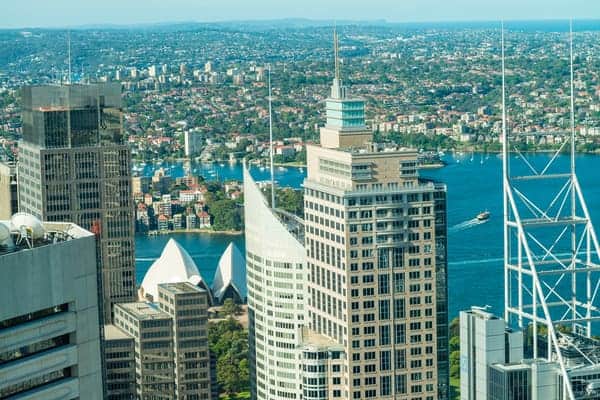 Aerial view of Sydney's skyline with the iconic Opera House and Sydney Tower, showcasing the city's urban landscape and addressing the question 'Is Sydney the Capital of Australia?' in the blog post.