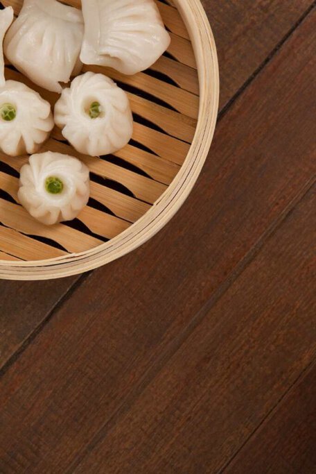 Delicate dumplings in a bamboo steamer, ready to be savoured as part of the culinary experiences on food walking tours in Sydney.