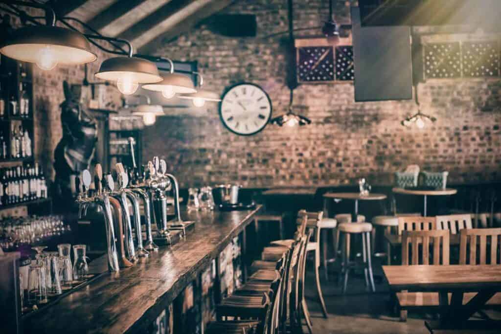 Vintage-style pub interior with wooden bar stools and a selection of taps, a setting reminiscent of the historic taverns visited on The Rocks pub tour in Sydney.