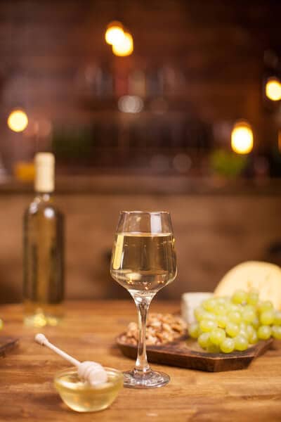 Wine tasting set-up in a vintage pub, featuring fresh grapes on a wooden table, a highlight of Melbourne to Yarra Valley wine trips.