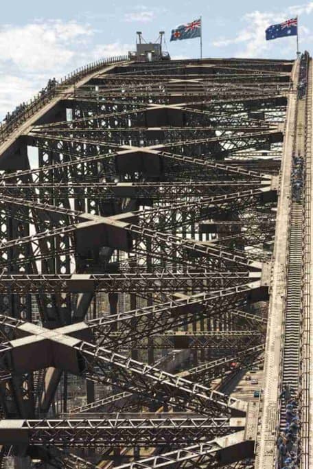 View of the intricate steelwork of the Sydney Harbour Bridge, showcasing its massive load-bearing structure, in relation to the post discussing the weight the Sydney Harbour Bridge can hold.