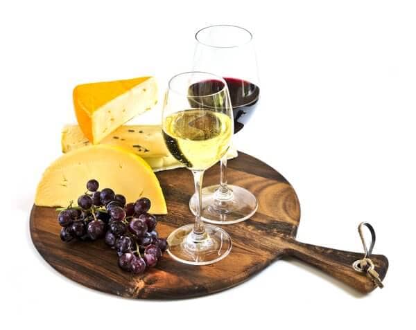 A wooden board featuring a selection of wine, cheese, and fruits, representing the culinary delights experienced on Yarra Valley wine tours from Melbourne.