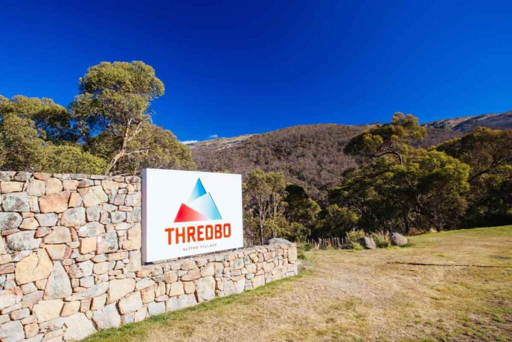 Entrance sign for Thredbo Alpine Village in Australia, a popular winter destination known for snow activities. While there is no snow near Brisbane, Thredbo offers an alpine experience for those seeking winter sports.