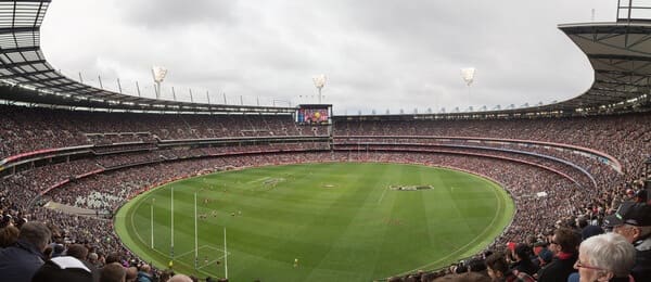A panoramic view of the Melbourne Cricket Ground filled with spectators during a winter sports event, a popular Melbourne pastime and a must-do for visitors in winter.