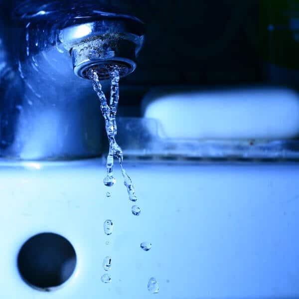 Close-up of water flowing from a tap, symbolizing concerns about the safety of drinking tap water in Bali.