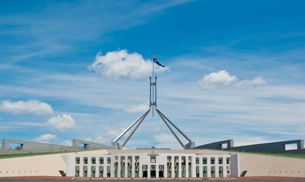 Parliament House in Canberra under a bright blue sky, symbolising the political heart of Australia in the context of Canberra vs. Adelaide travel choices.