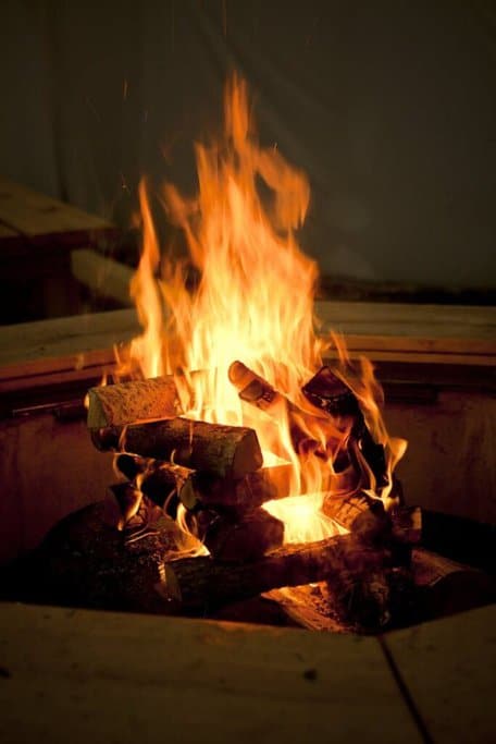 Crackling bonfire with intense flames and glowing embers, ideal for Halloween rituals in Australia to create a spooky, enchanting atmosphere.