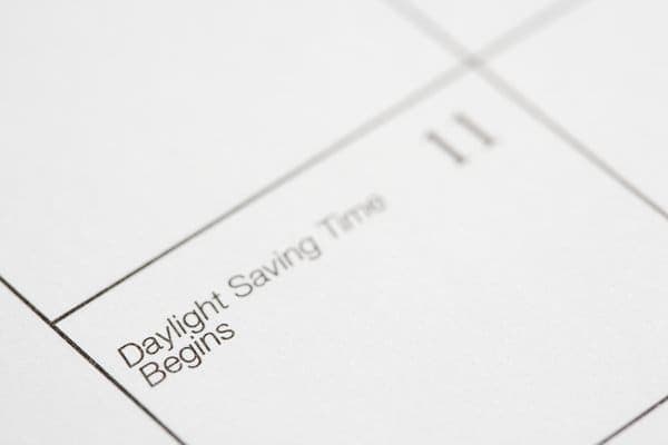 Close-up of a calendar page with 'Daylight Saving Time Begins' marked on it, highlighting the seasonal time change that can affect time zone differences, relevant to the discussion on whether Melbourne and Sydney have the same time zone.