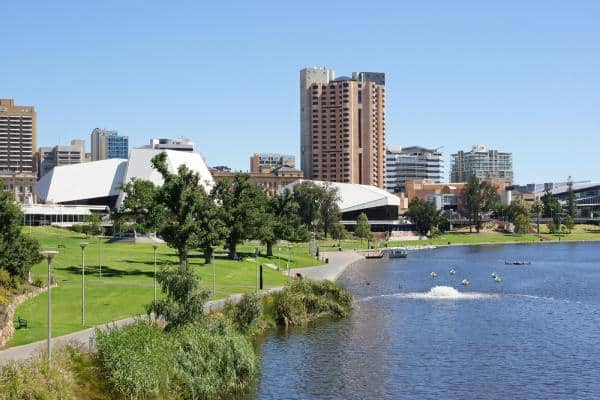 Scenic view of Adelaide's riverfront, showcasing the vibrant cityscape near top hotels with indoor pools in Adelaide, highlighting Adelaide's urban charm and leisure facilities.