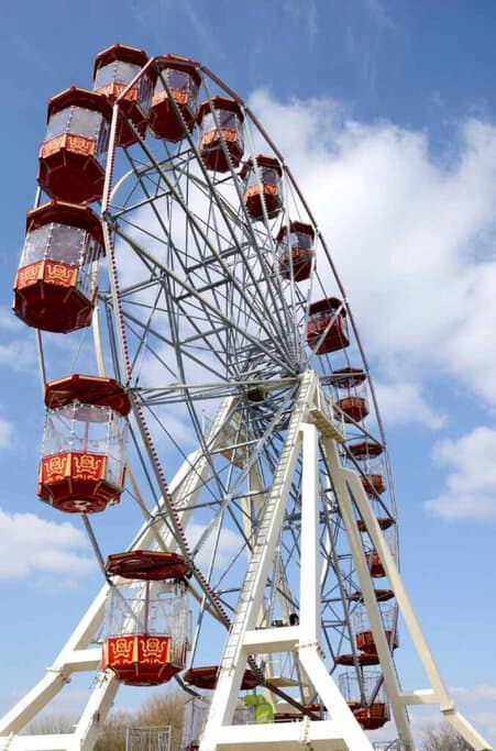 Ferris wheel at the Royal Queensland Show, set against a bright blue sky, showcasing a classic attraction of Brisbane's popular event. The image highlights Brisbane's warm weather, raising the question 'does it snow in Brisbane,' given the city's typically sunny, snow-free climate.