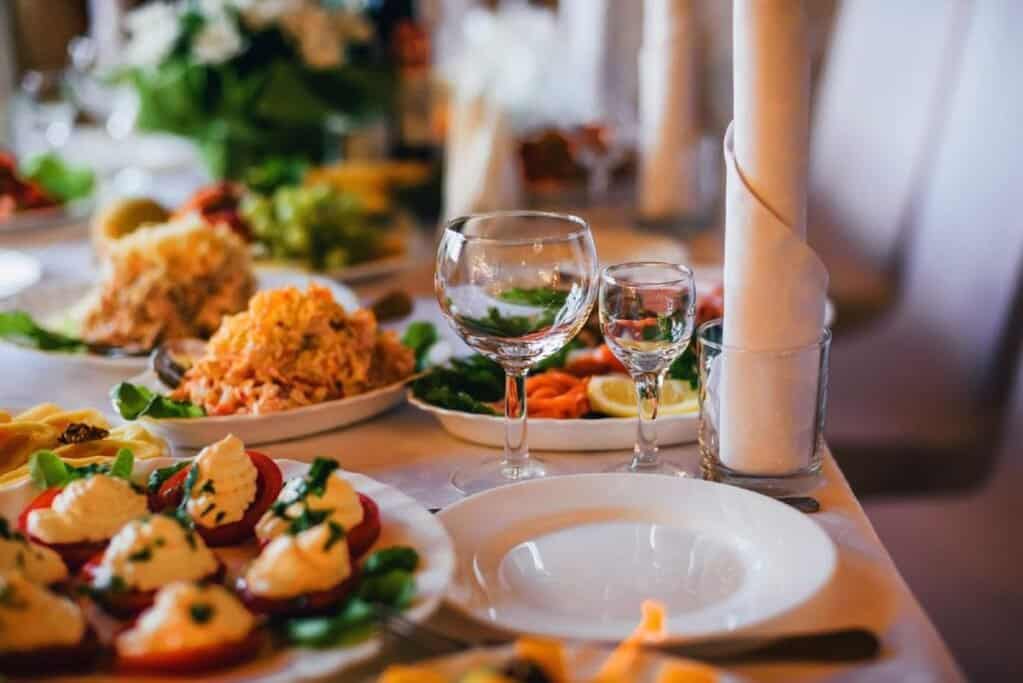 Elegantly set dinner table with an array of dishes, ideal for a 'silent supper' as a Halloween ritual, creating a unique, thematic dining experience.