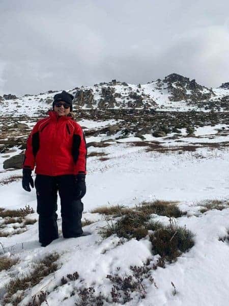 The author, Kate, standing confidently in Thredbo on a snow-dusted trail, ready to explore the natural beauty that snow tours from Sydney offer.