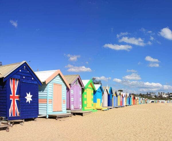 Colourful bathing boxes lined up on Brighton Beach in Victoria, showcasing the vibrant coastal lifestyle, relating to the best places to live in Victoria for beach enthusiasts.