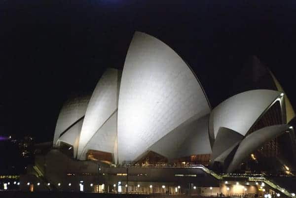 Night view of the Sydney Opera House, highlighting its unique architectural design, in relation to the common misconception addressed in the blog post 'Is Sydney the Capital of Australia?
