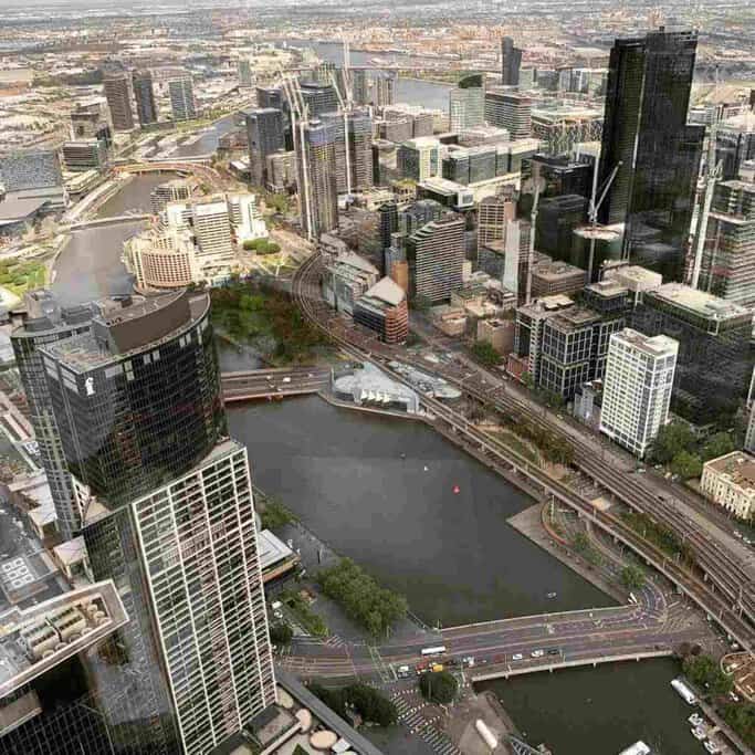 An aerial view of Melbourne's central business district (CBD), featuring a network of roads, skyscrapers, and the winding Yarra River, representing the bustling heart of the city. This image complements the 'Australia Travel Hub' by showcasing one of Australia's most dynamic urban centres, ideal for travellers exploring Melbourne.