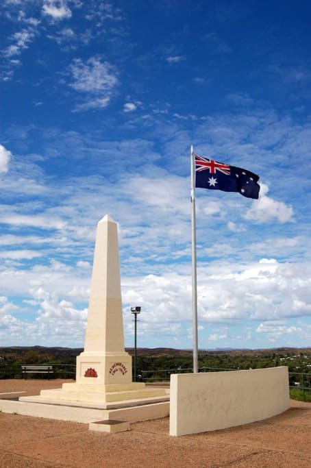 Anzac Hill War Memorial in Alice Springs, featuring a striking obelisk and the Australian flag, offering panoramic views and a reflective spot for those exploring Alice Springs.