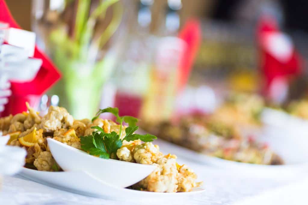 Close-up of a Christmas lunch banquet table with a dish of fried food garnished with parsley, representing a festive Christmas Day lunch in Melbourne, highlighting popular dining options in the city.