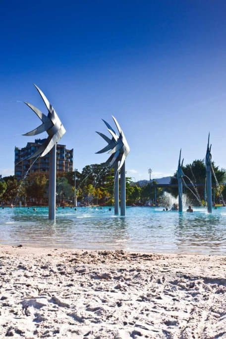 Beach with iconic fish sculptures at Cairns Esplanade, showcasing a popular spot for outdoor celebrations during Christmas in Cairns.