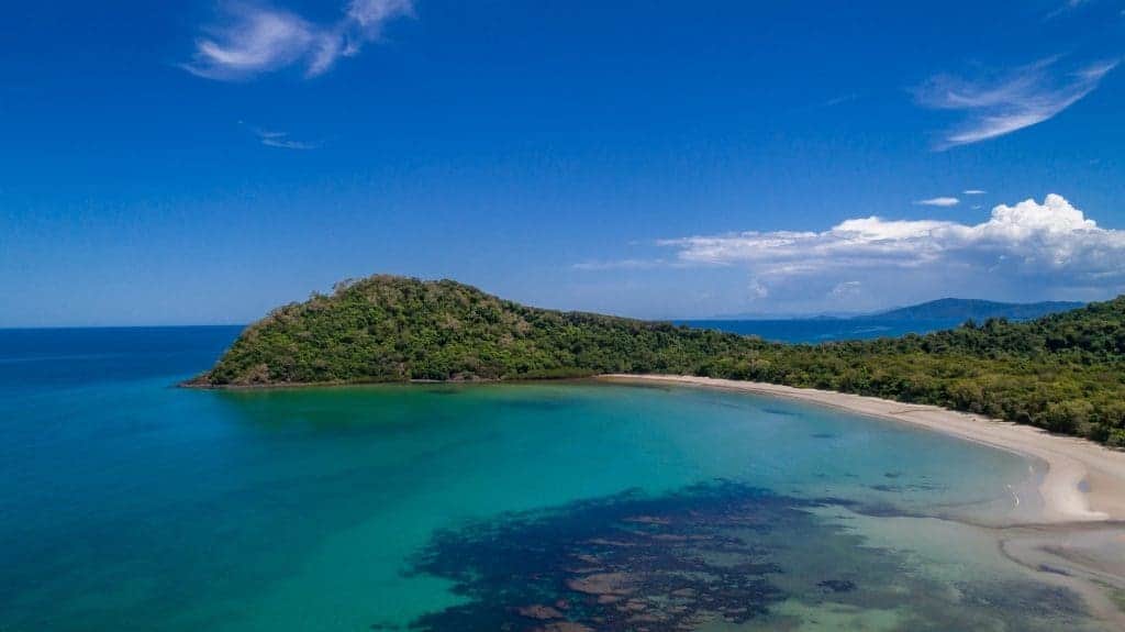 Aerial view of Cape Tribulation in Queensland with lush greenery and a tranquil bay, a hidden gem perfect for nature lovers exploring Australian travel destinations.