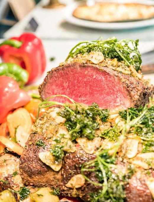 Succulent roasted wagyu beef garnished with herbs and garlic, alongside fresh vegetables, showcasing one of the best Christmas lunch spots in Melbourne, known for its festive gourmet offerings.