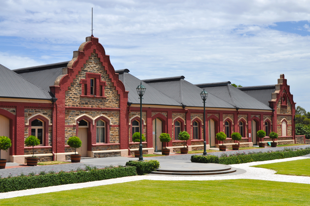 Historic chateau-style building of Chateau Tanunda with red brick and stone facade in Barossa Valley, showcasing the architectural beauty and heritage, one of the popular things to do in Barossa Valley.