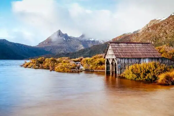 An idyllic boathouse on the serene waters of Dove Lake with Cradle Mountain in the background, showcasing the natural beauty of Tasmania. This image invites readers to explore Australia, highlighting the picturesque landscapes that await in the country's diverse regions.