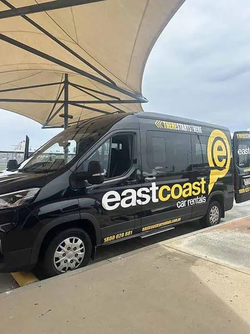 East Coast Car Rental shuttle bus in action, picking up passengers from the airport to the depot, showcasing convenient transportation for car rental on the Gold Coast.