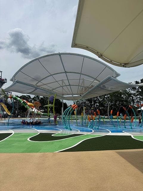 Colourful water play structures under the shade of a large canopy at H2Oasis in Wet'n'Wild Gold Coast, capturing the family-friendly atmosphere discussed in our Wet'n'Wild Gold Coast review.