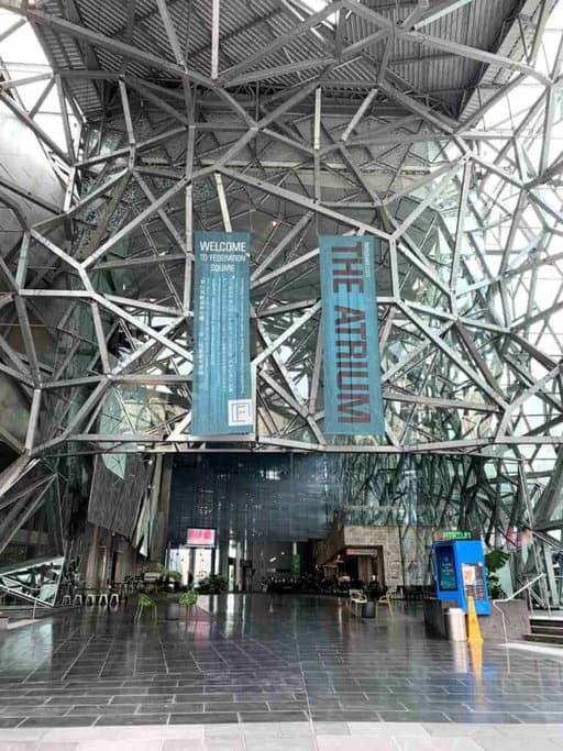 The Atrium at Federation Square in Melbourne, featuring intricate metal and glass architecture. This space, part of one of the world's best public squares, is known for its striking design and is one of Melbourne’s Most Instagrammable Locations.