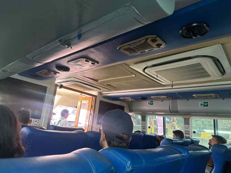 Interior view of the Blue Water Express fast boat, with passengers seated and ready for departure on their journey on how to get to the Gili Islands from Bali.