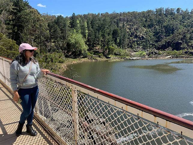 Photo of the author standing on the Alexandra Suspension Bridge in Cataract Gorge, highlighting a nearby attraction to explore when considering where to stay in Launceston.