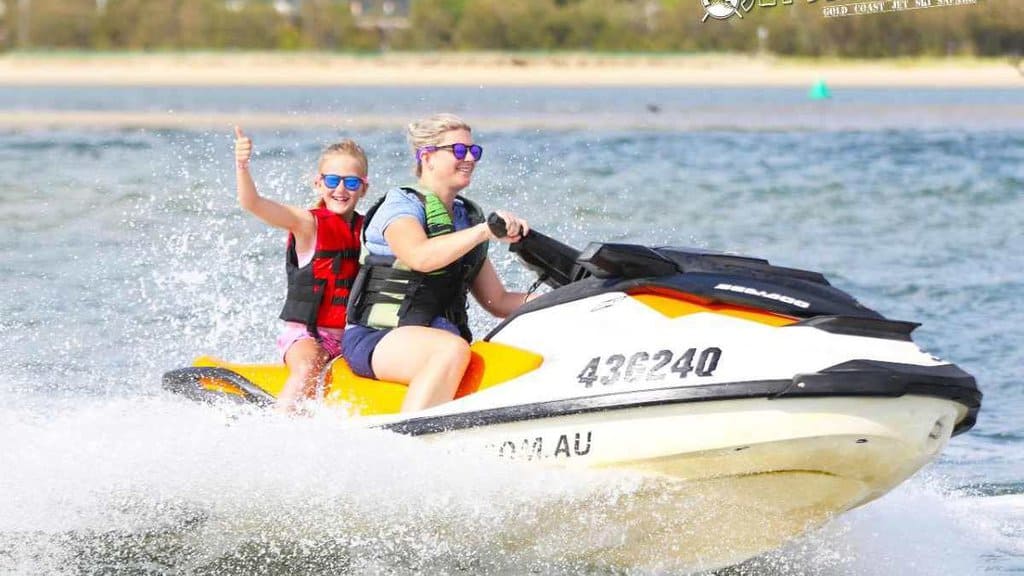 Mother and daughter enjoying an exciting jet ski ride on the Hawkesbury River, showcasing a fun and adventurous family activity.