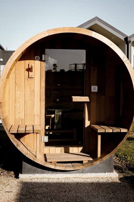 A distinctive circular wooden sauna as part of this luxury cabin in Branxholm, inviting guests into a warm and intimate space that promises a unique stay amid the cabin's high-end facilities.