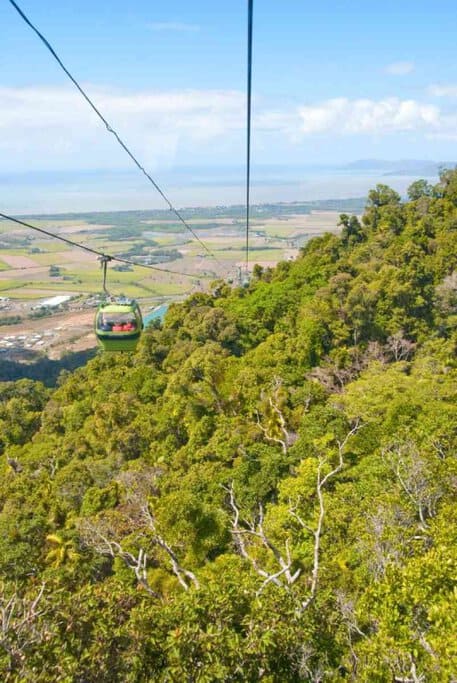 Scenic view from the Kuranda Skyrail Rainforest Cableway, offering breathtaking sights of the lush rainforest and coastal plains of Queensland. A must-try outdoor adventure activity in Queensland for nature lovers and thrill-seekers.