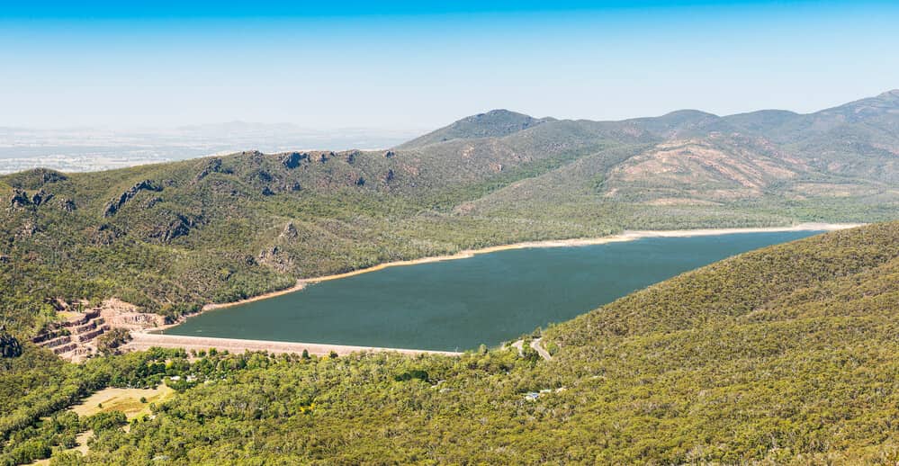 Serene view of Lake Bellfield surrounded by lush greenery, reflecting the peaceful essence of camping in the Grampians.