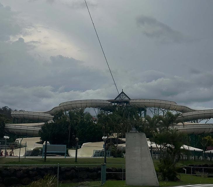 A towering Mammoth Falls water slide at Wet'n'Wild Gold Coast, set against a cloudy sky, encapsulates the thrilling experiences highlighted in our Wet'n'Wild Gold Coast review.