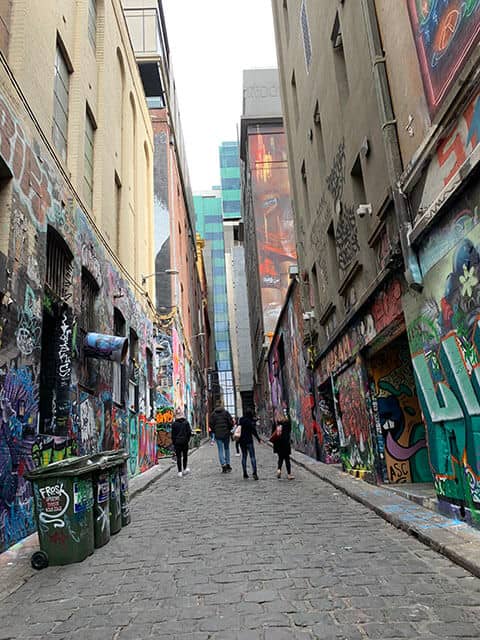 Melbourne laneways in Hosier Lane, adorned with diverse graffiti art, showcasing the city's vibrant culture and why Melbourne is worth visiting.