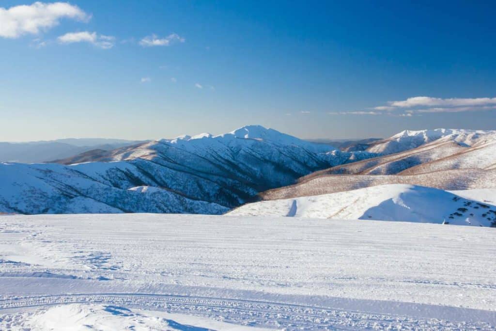 A breathtaking winter landscape of Mount Feathertop blanketed in snow, a popular destination for adventure seekers exploring hiking trails in Victoria’s alpine region.