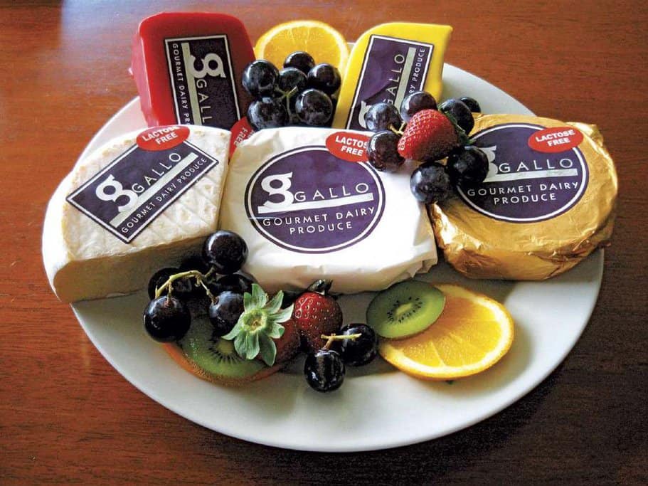 Assorted platter of gourmet cheeses and fresh fruits, part of the culinary experiences you can enjoy when you explore Port Douglas, showcasing local produce and dairy specialties.
