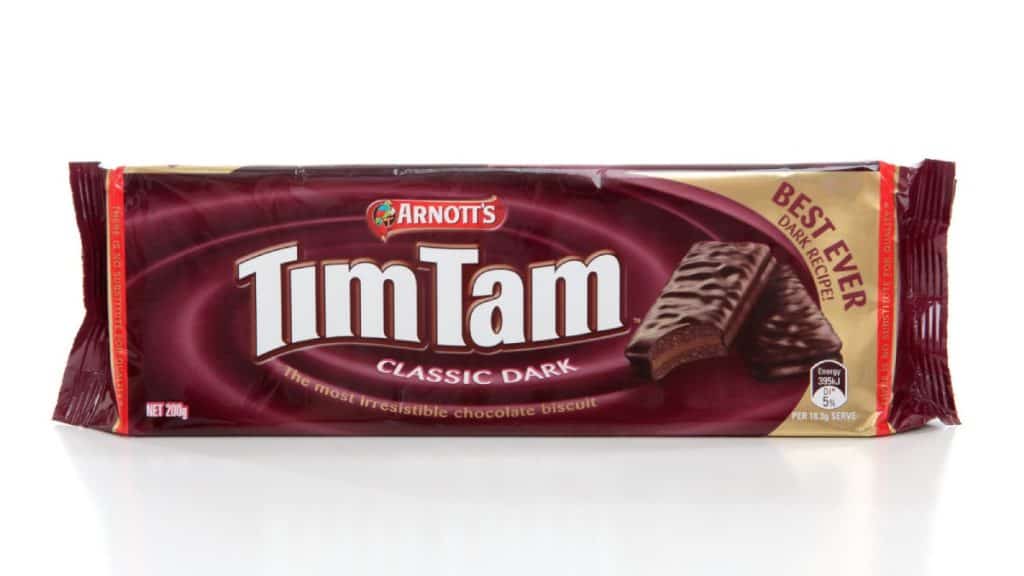 A packet of Arnott’s Tim Tam Classic Dark chocolate biscuits, one of the most iconic Aussie snacks. These chocolate-coated biscuits are a favourite treat in Australia, known for their rich flavour and indulgent texture.