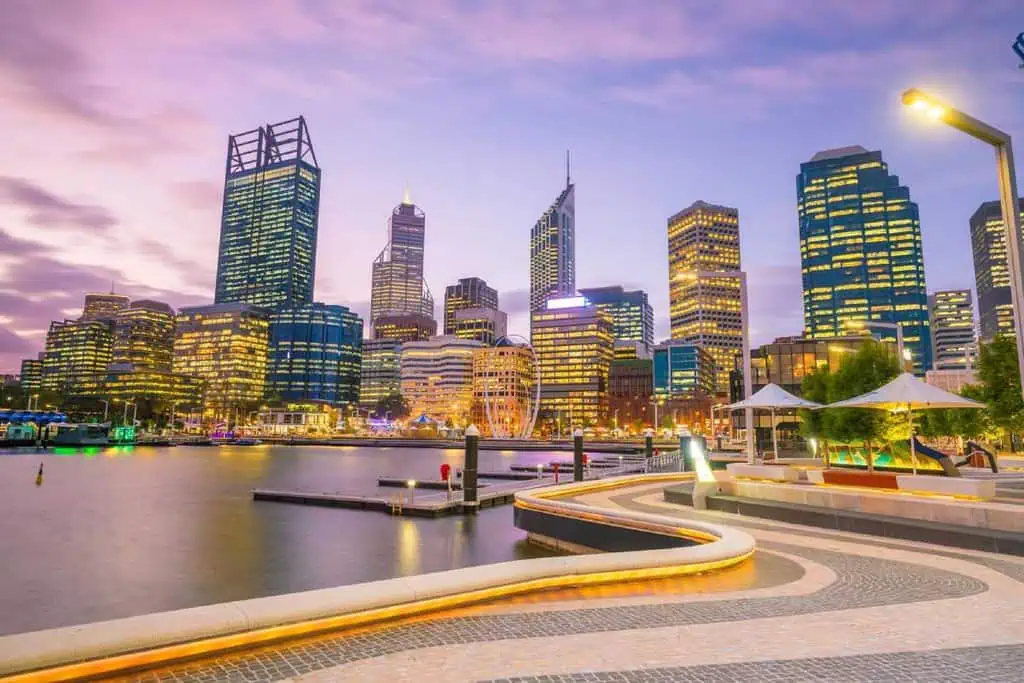 The illuminated Perth skyline at dusk, highlighting the vibrant city that marks the beginning or end of a journey from Perth to Adelaide.