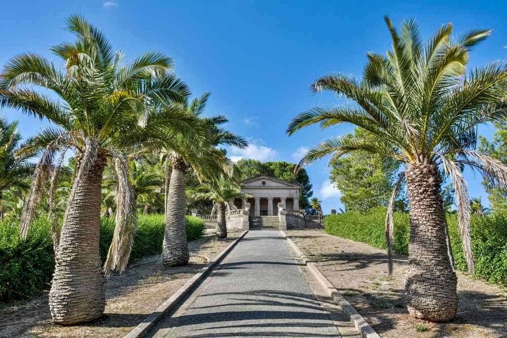 Palm-lined driveway leading to the historic Seppelt Family Mausoleum in Nuriootpa, Barossa Valley—showcasing the region’s rich heritage and peaceful surroundings that appeal to those considering the lifestyle benefits and drawbacks of living in Barossa Valley.