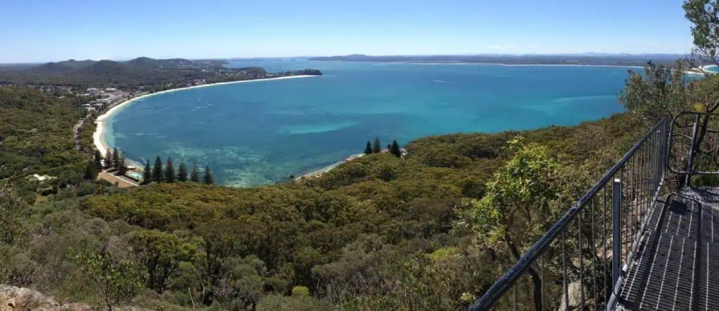 Sweeping panoramic view over Shoal Bay and the surrounding coastline from the summit of Mount Tomaree, a breathtaking lookout on the Sydney to Byron Bay driving route.