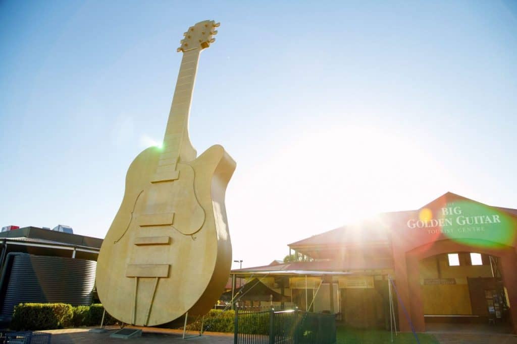 The iconic Big Golden Guitar shining under the sun outside the Tamworth Visitor Centre, marking the heart of the Tamworth Country Music Festival — one of the top Epic Australian Festivals for live music lovers.