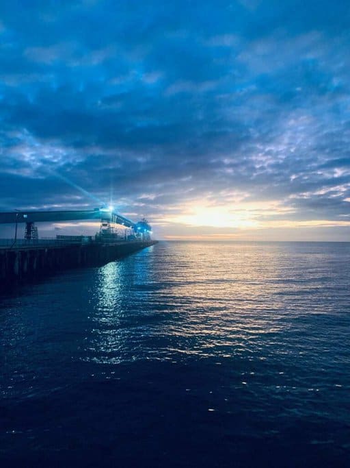 Sunset view over the ocean at Wallaroo, with a pier extending into the water under a colourful sky. This serene coastal scene illustrates the beauty of Wallaroo, enhancing the appeal of Australia travel deals for visitors seeking picturesque and relaxing destinations.