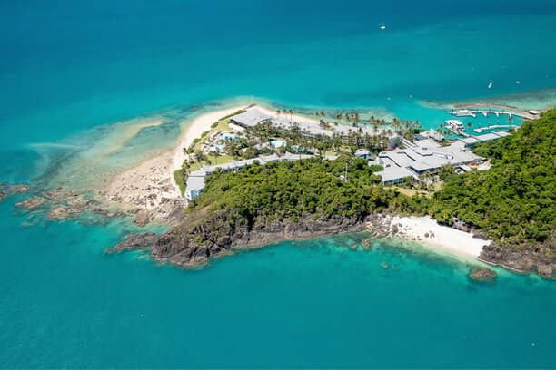 Aerial view of the Whitsunday Islands, with their crystal-clear waters and pristine beaches, exemplifying Australia's appeal as a romantic honeymoon destination.